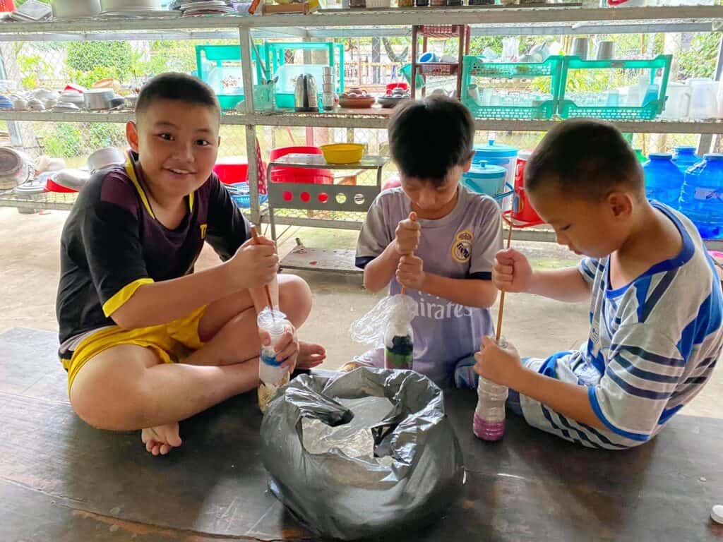 kids filling plastic bottles