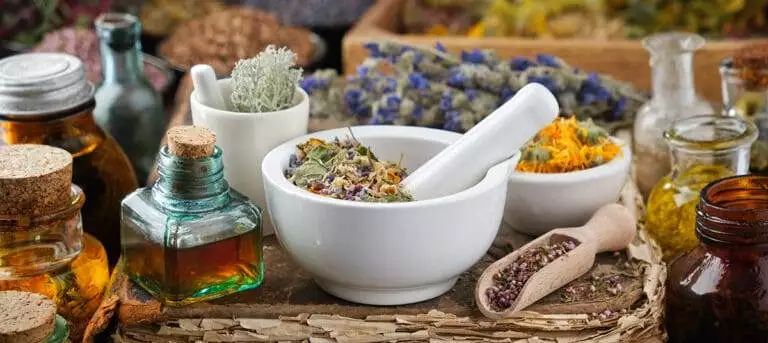 bottles of healthy infusion or oil, mortars and bowls of medicin
